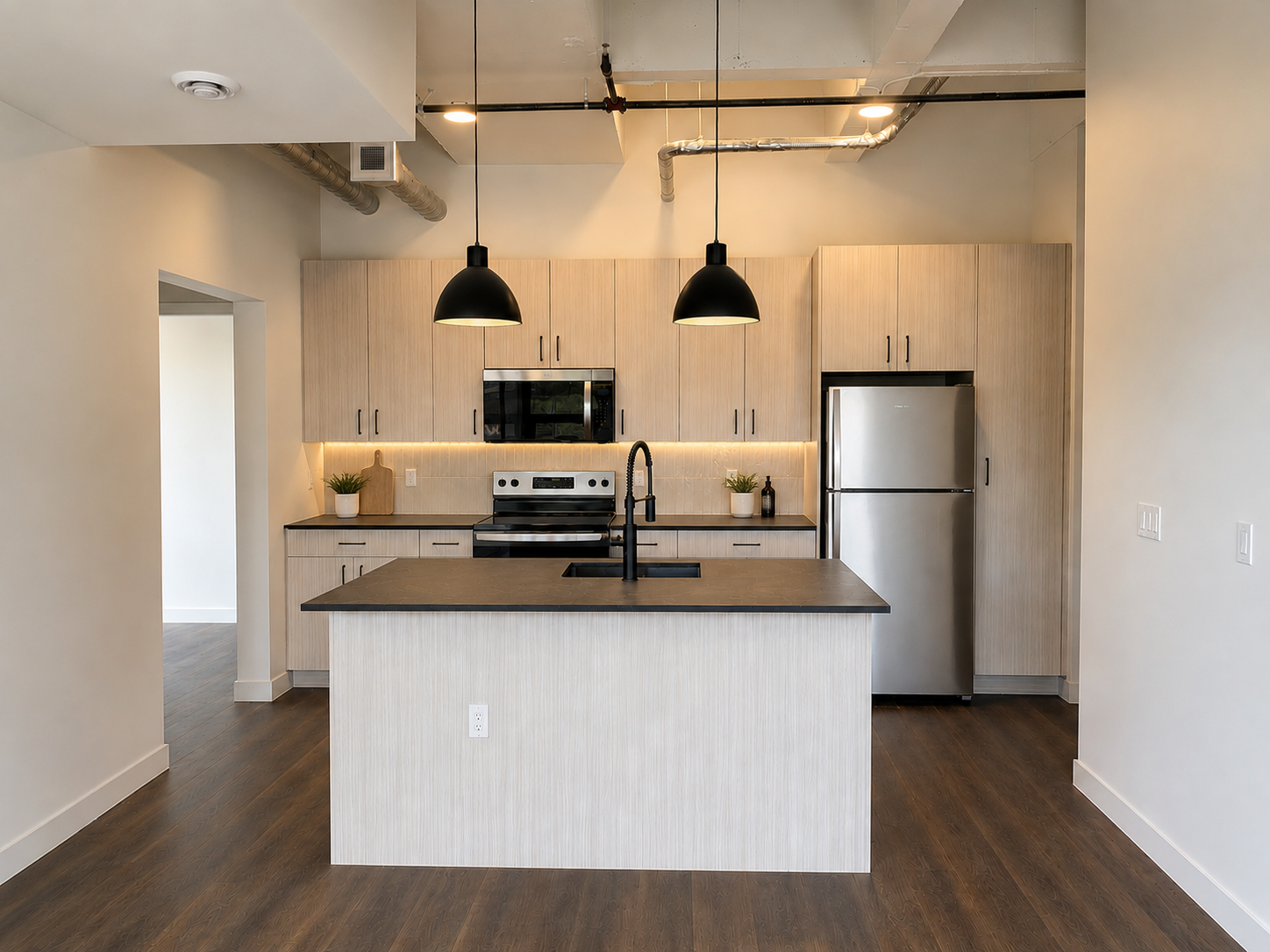 Stainless steel appliances and quartz countertops at Rejuvenate Apartments